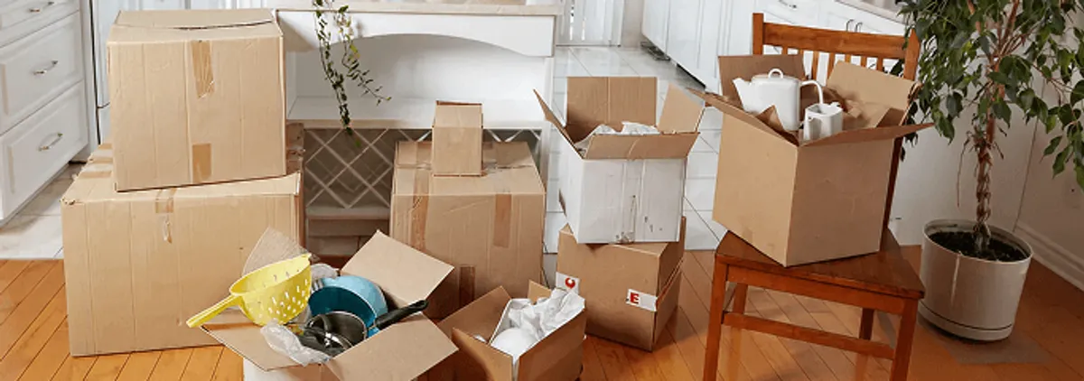 Packed moving boxes and household items in a kitchen before move-out or move-in cleaning, Cedar Rapids, IA.